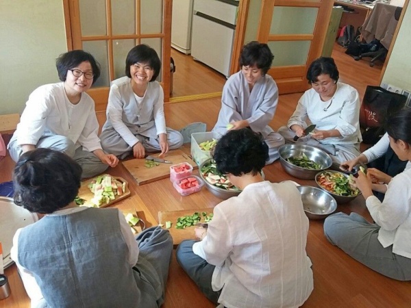 옹기종기 모여 앉아 수박 껍질 처리하는 동래법당 도반들(앞모습 왼쪽에서 세 번째 김경희 님)